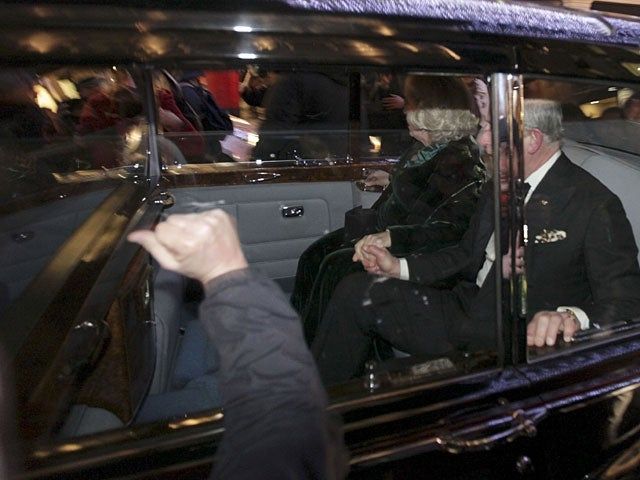 A fist banging on the glass of the window of the limo 