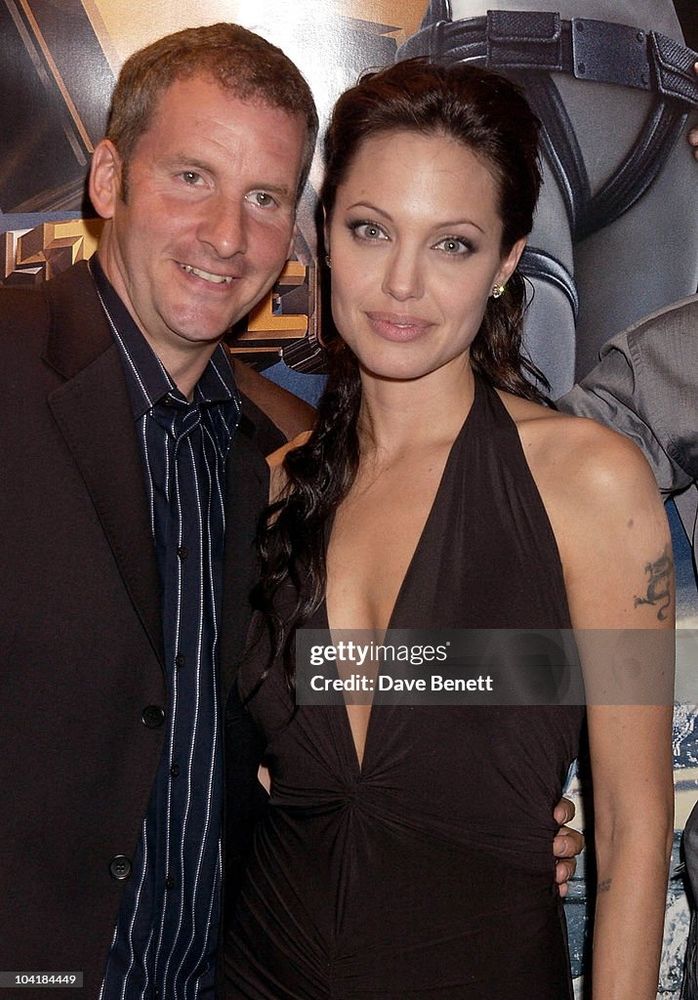 Getty images of Chris Barrie and Angelina Jolie at a premier for a Tomb Raider movie. 
