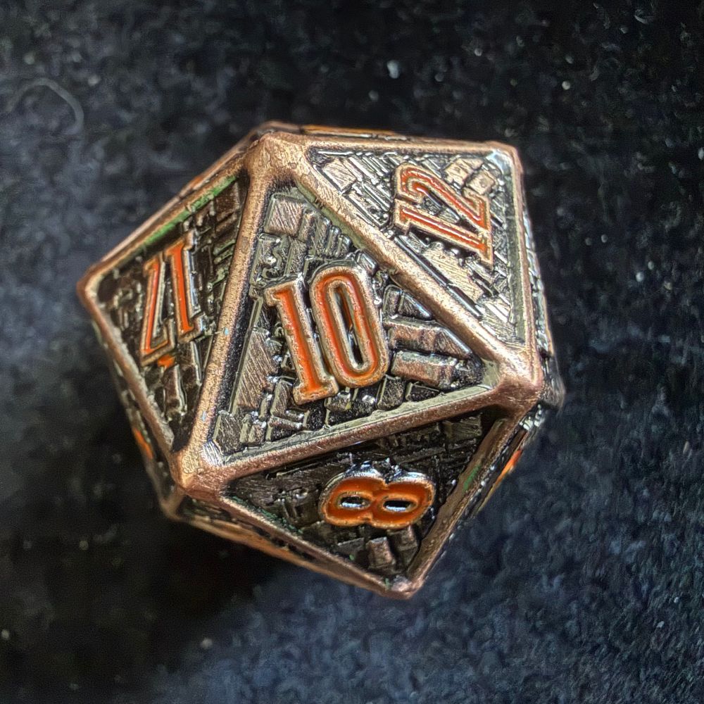 Brown and copper metal d20 showing a red 10…