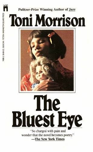 Picture of a paperback book cover of "The Bluest Eye" by author Toni Morrison. Cover has a white background with a small image in the center of a black girl with pinkish bows in her hair, holding a blonde white doll.