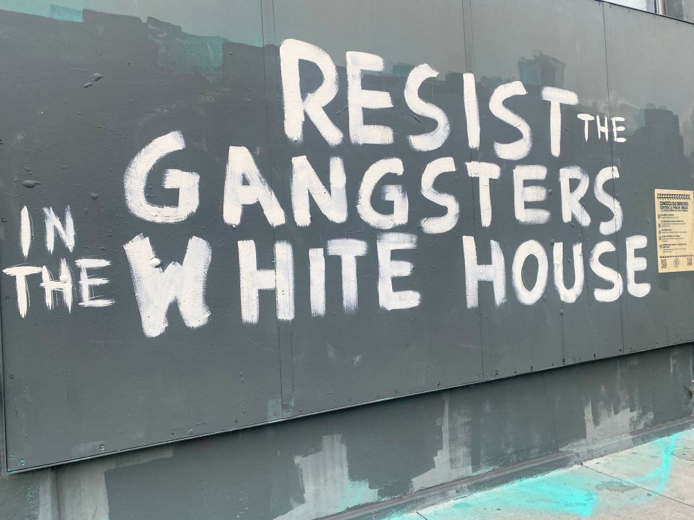 Graffiti on a building that declares: “resist the gangsters in the White House”