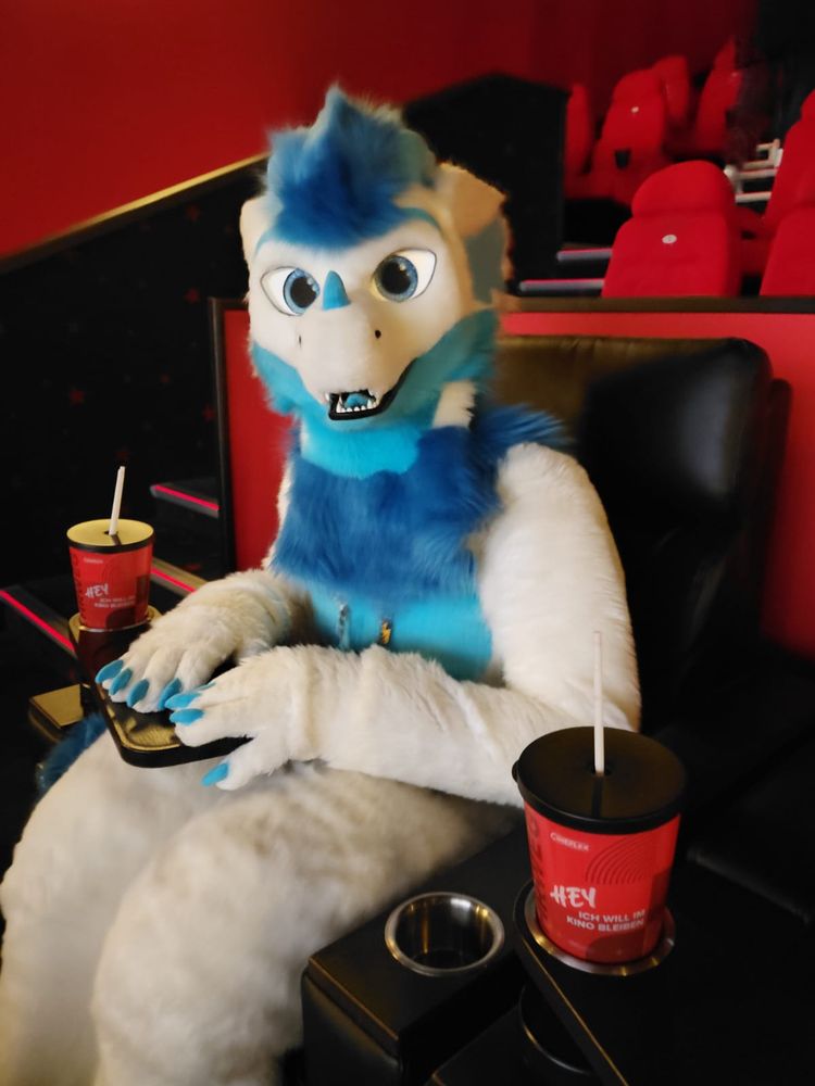 In the picture you can see Reiko in fursuit sitting in a cinema chair looking excited for the movie