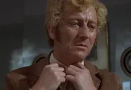 Still from the movie Frenzy with actor Barry Foster undoing his tie before murdering a woman