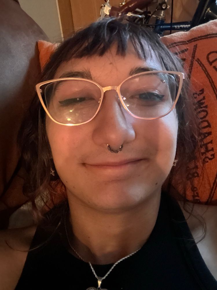 Maia laying on the couch, smiling and clearly drunk