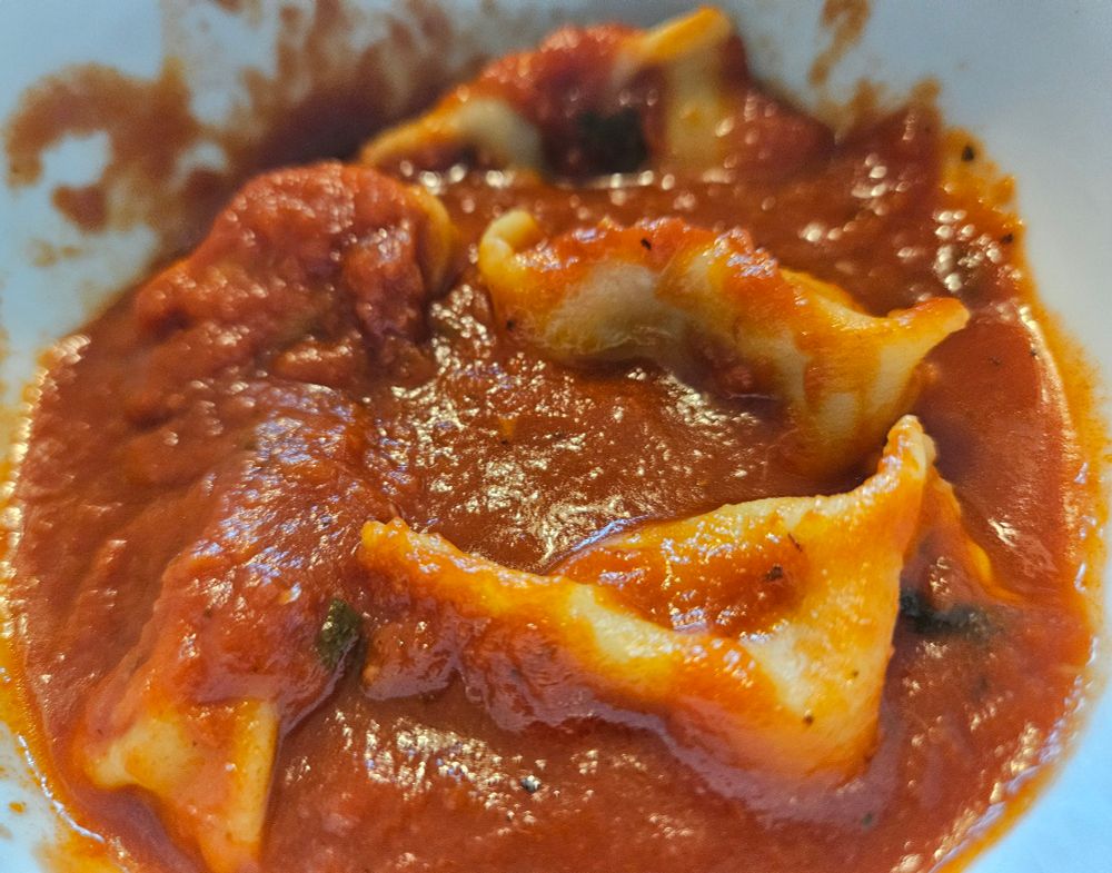 Agnolotti del Plin stuffed with cheese steak ingredients, topped with 6-hour Sunday Gravy 