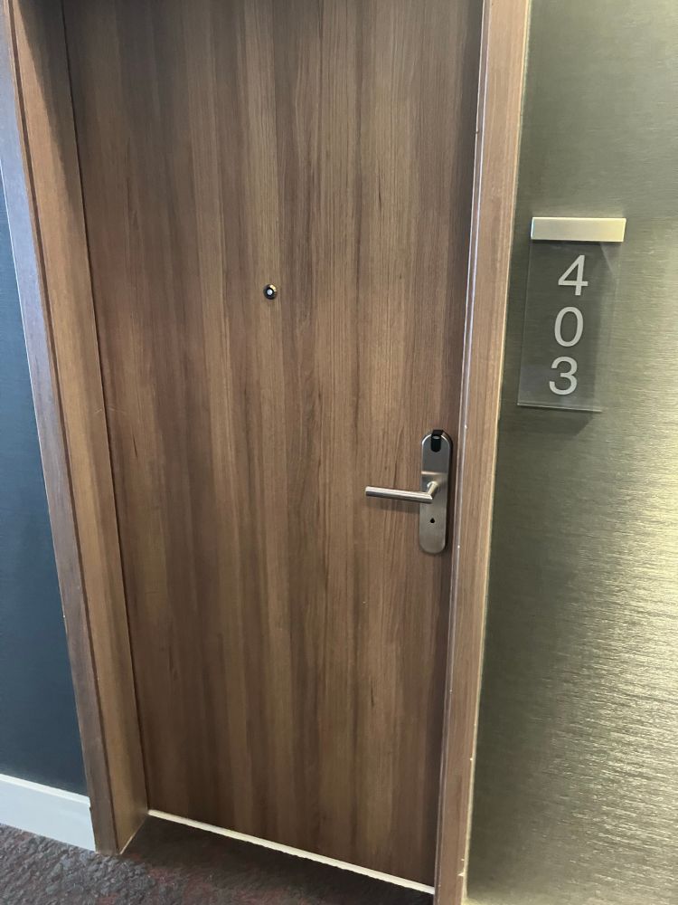 Hotel room door with room number “403” next to it.