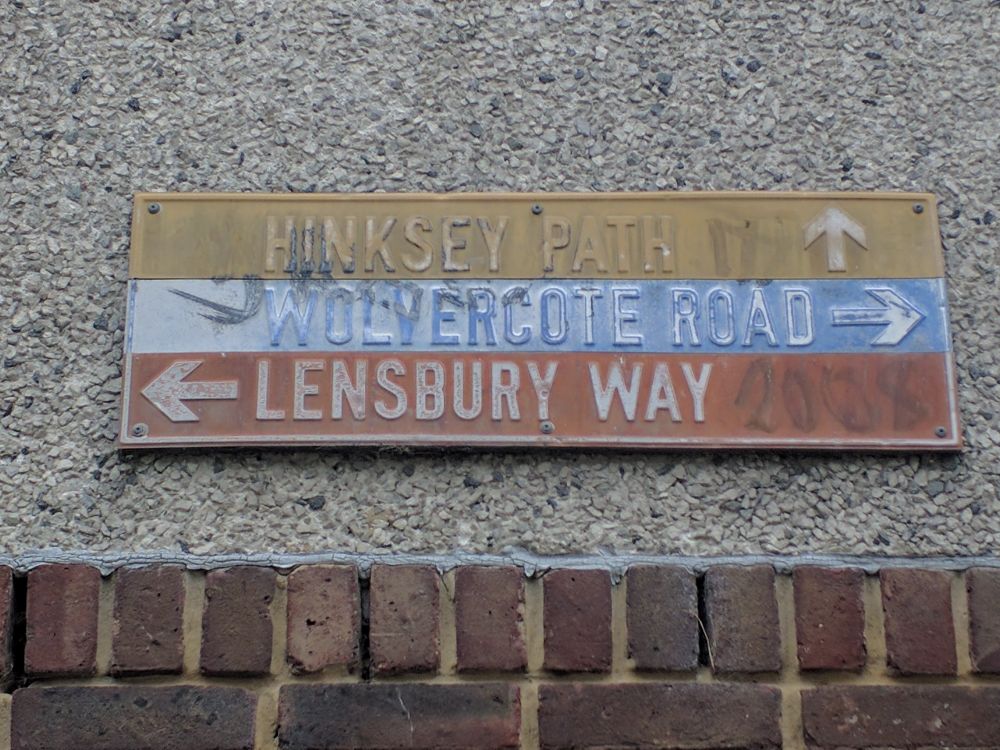 Colour coded pressed metal directional sign from Thamesmead