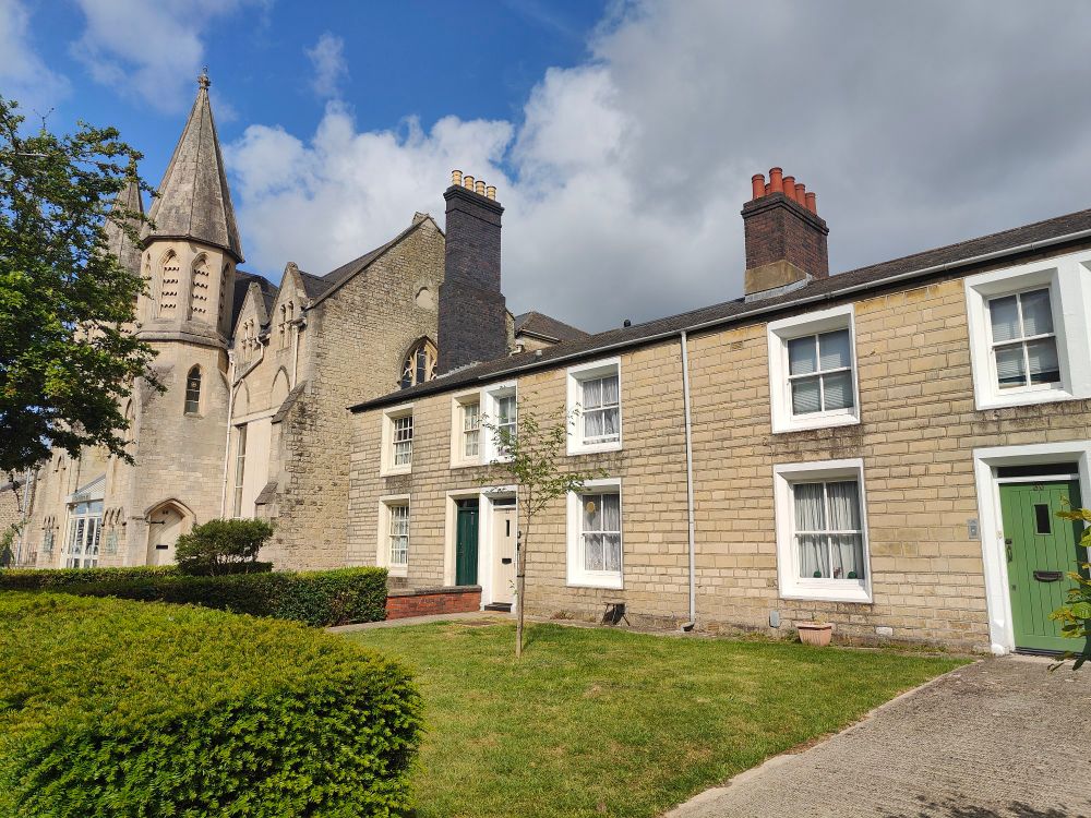 Stone built terrace houses, with the former lodging house behind 