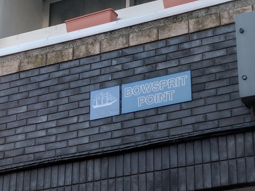 Blue (LDDC?) sign reading Bowsprit Point, with an image of a ship.