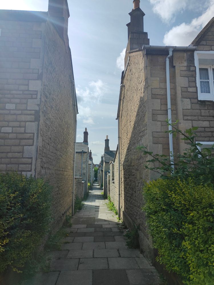 A narrow alleyway between terrace houses