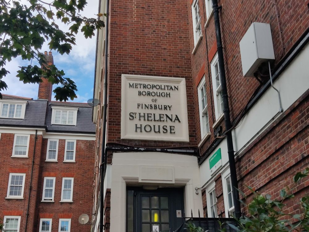 Individual bronze letters on white painted concrete: METROPOLITAN BOROUGH OF FINSBURY 
ST. HELENA HOUSE 