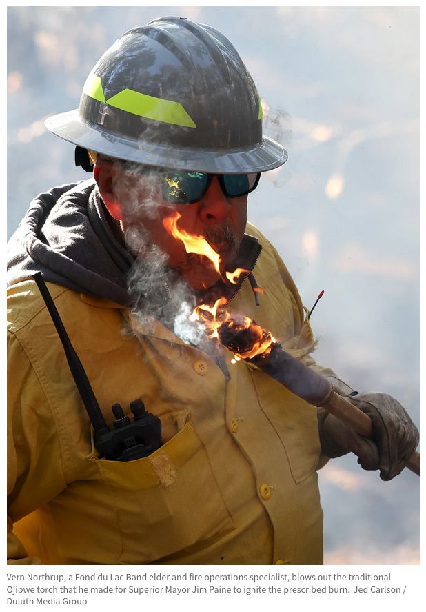 Vern Northrup, a Fond du Lac Band elder and fire operations specialist, blows out the traditional Ojibwe torch that he made for Superior Mayor Jim Paine to ignite the prescribed burn. Jed Carlson / Duluth Media Group