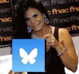 a woman in a black dress is holding a blue box with a white butterfly on it