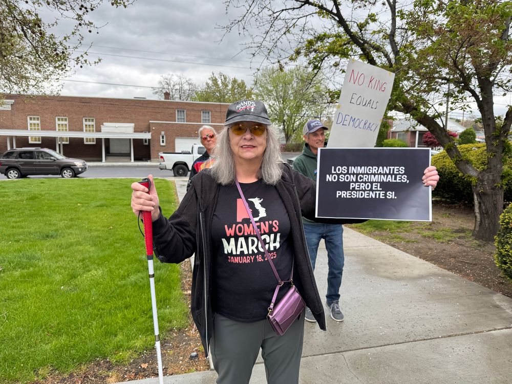 Protester in Pendleton Oregon holding us sign that in Spanish says immigrants are not criminals, but the president is