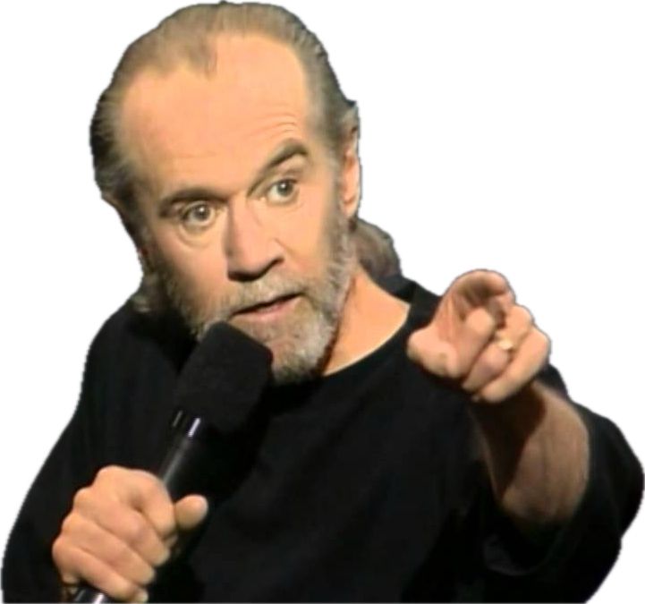 90s George Carlin in black sweatshirt pointing with one hand and holding a mic with the other
