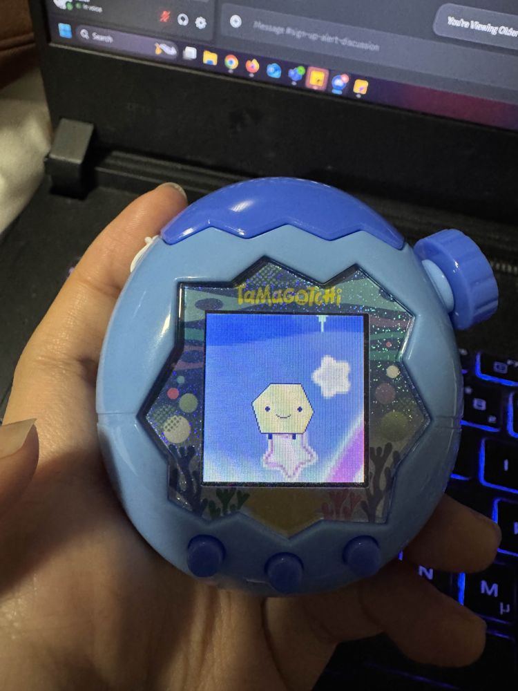 tamagotchi shaped like a messed up hexagon