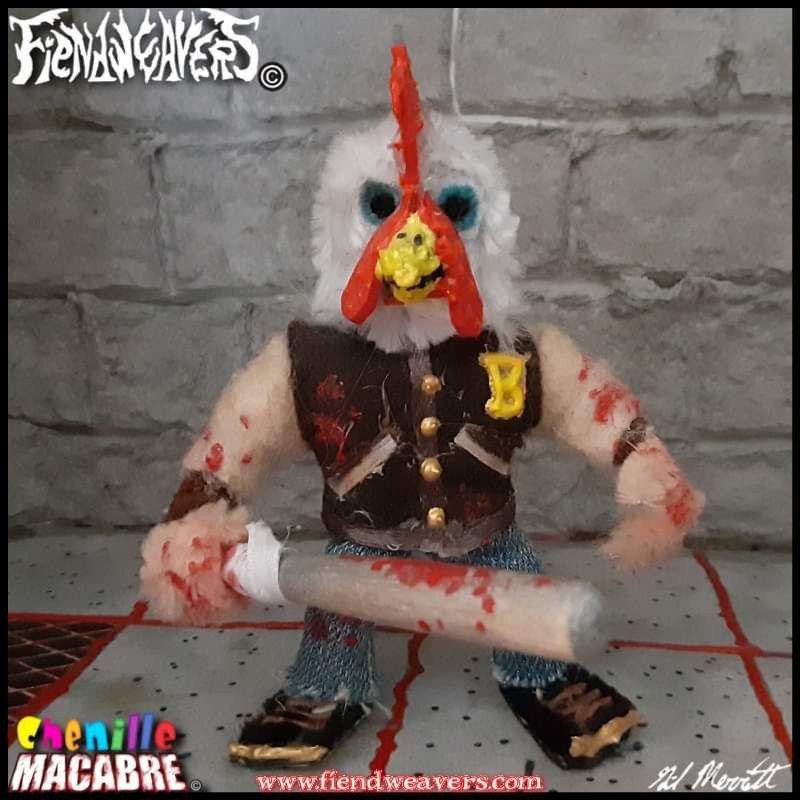 A pipe cleaner figure I built of "Jacket" from the video game Hotline Miami. He wears a white chicken mask, his letter jacket, and jeans. He wields a bloody aluminum bat. His head and arms come off for AMPUTHEATRE combat and he stands 3" (7.62 cm) high.