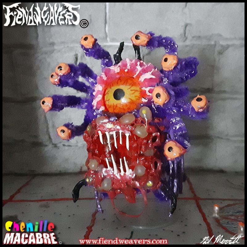 A pipe cleaner figure i built of a Beholder from Dungeons & Dragons. It is a floating purple spherical monster with a single yellow eye and a rotted mouth covered in boils. Ten smaller eyes jut from the monster on stalks. It "floats" by means of a plastic drum and stands 3" (7.62 cm) high.