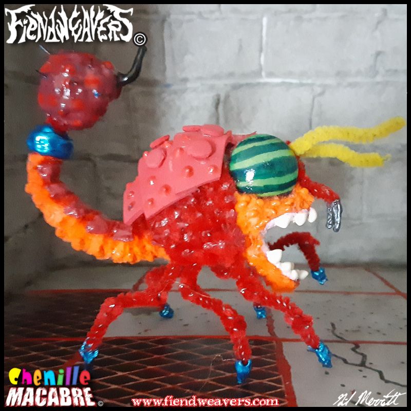 A pipe cleaner figure I built of a Thorwor, a monster from the 1980 video game WIZARD OF WOR. The Thorwor is (to my understanding of its pixelated form) is a red scorpion/reptile hybrid with six segmented legs, a large mouth, and a poison stinger. It has yellow antenna and giant eyes like those of a horsefly.