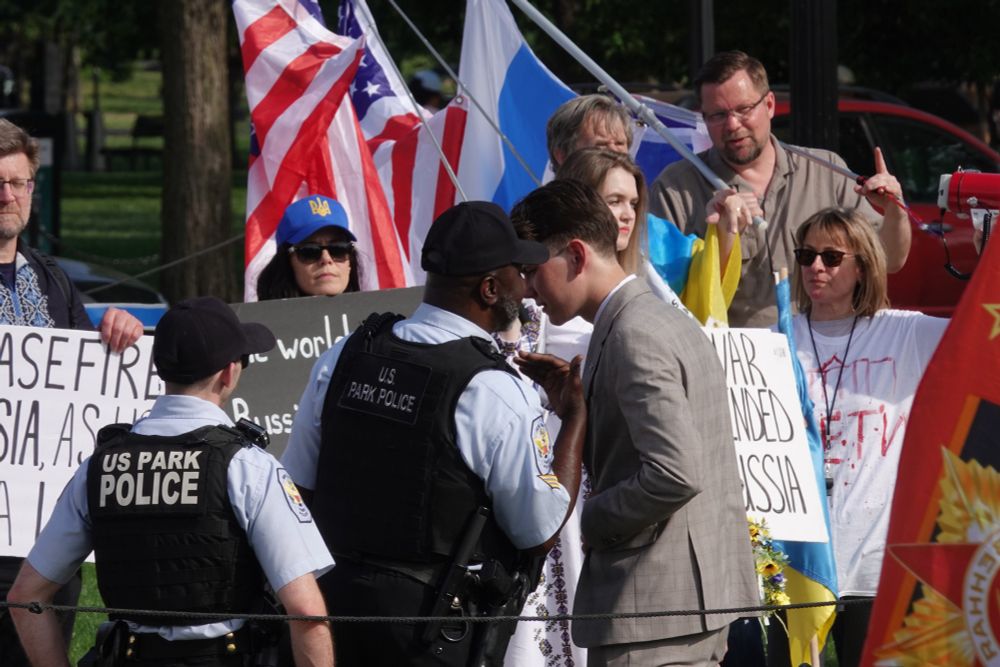 Police approach the Ukranian counter-protest to demand they cease using megaphone sirens