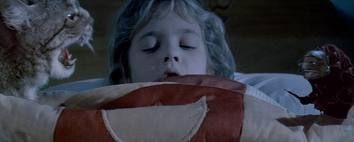 a scene from the movie the cat's eye, which features a variety of stories that feature a cat who is making his way to protect a young drew barrymore from a tiny little monster who steals her breath because she is callng him on the psychic plane.
The scene shows the cat facing off against the monster while drew barrymore sleeps