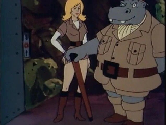 a shot from the old plastic man cartoon show that features the villain known as the hippotist with his blonde, female assistant.
they are both dressed like they are on african safari and the hippotist is an anthropomorphic hippo with a cravatte and a monacle and a cane. he can hypnotize people almost instantly