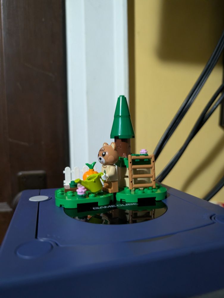 The LEGO Animal Crossing "Maple's Pumpkin Garden" set sitting on top of an Indigo Gamecube