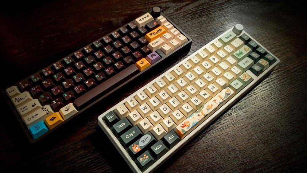 Two 65% mechanical keyboards with a knob. One is brown one is white.