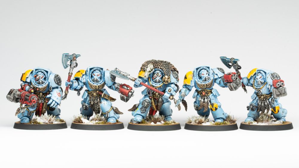 Space Wolves Wolf Guard Terminators. 5 warriors in blue-grey terminator armour with yellow details and red weapons. They wield a variety of guns and axes