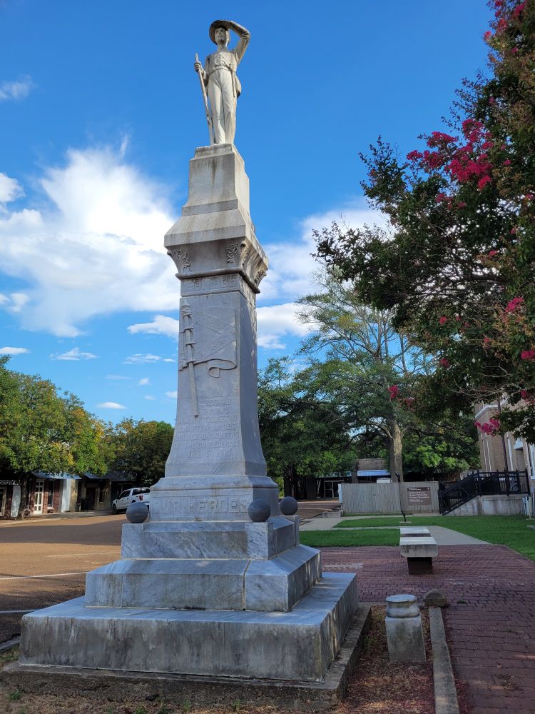 Till national monument sign with Confederate statue in foreground 