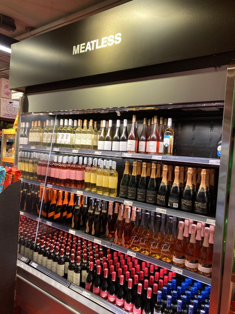A photo of a display of chilled wine labeled “MEATLESS”