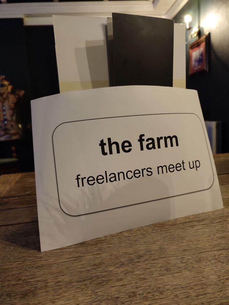 A printed sign on a white A4 sheet
The Farm freelancers meet up 