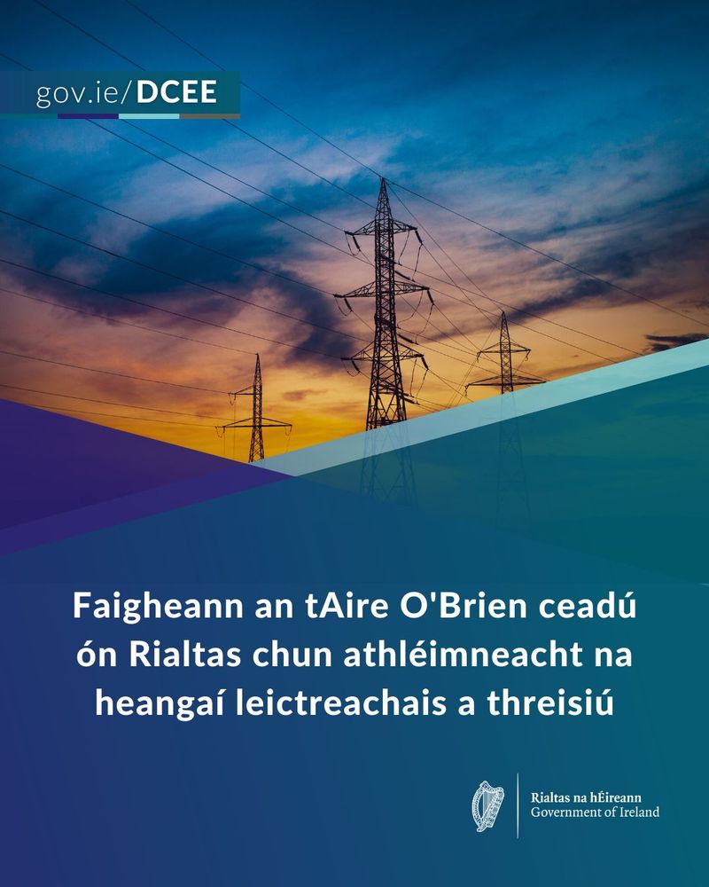 Two power transmission towers silhouetted against a colorful sunset, with text about energy infrastructure in Ireland.