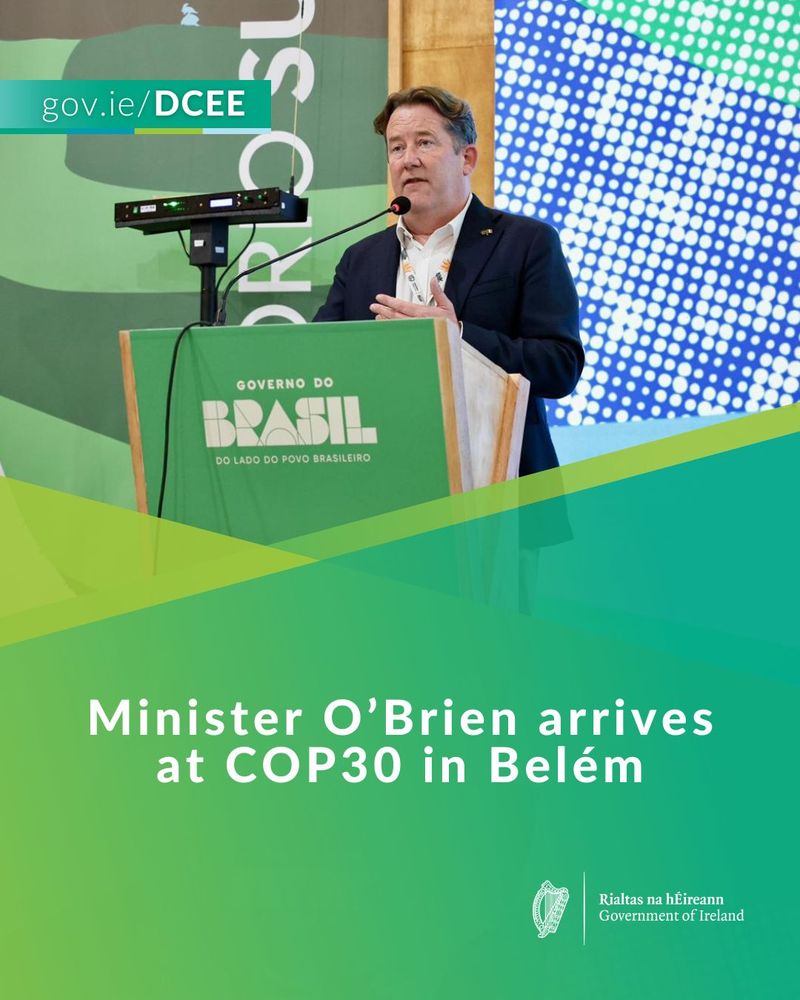 Minister O'Brien standing at a podium with gov.ie/DCEE logos, speaking at COP30 in Belém.