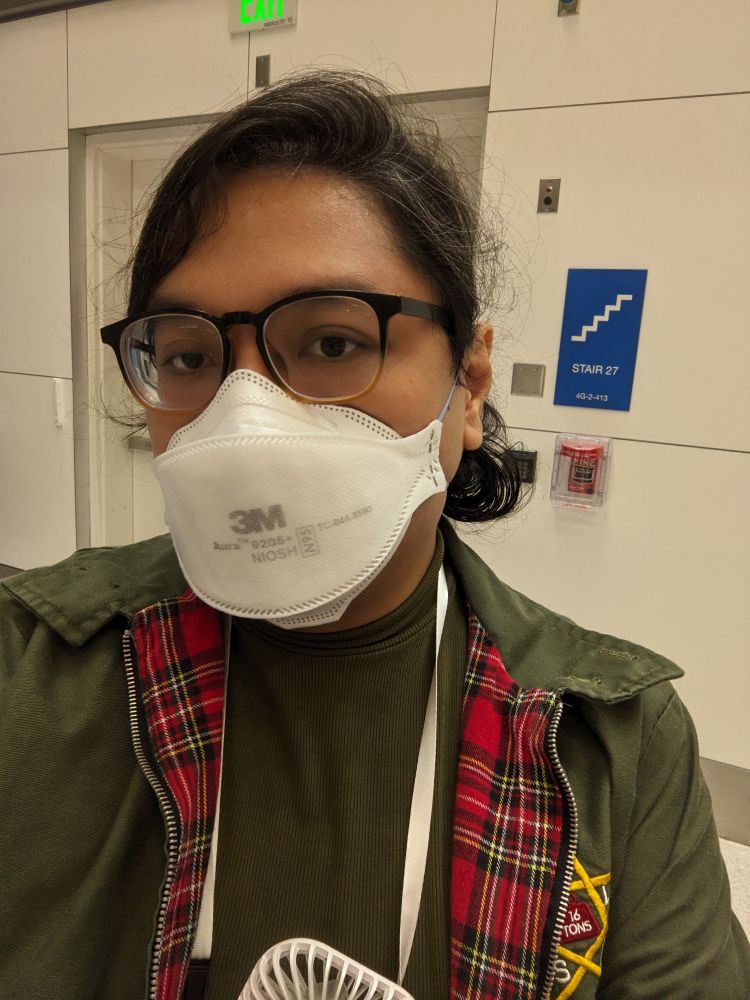 selfie of me wearing a white mask, green shirt, and green jacket 