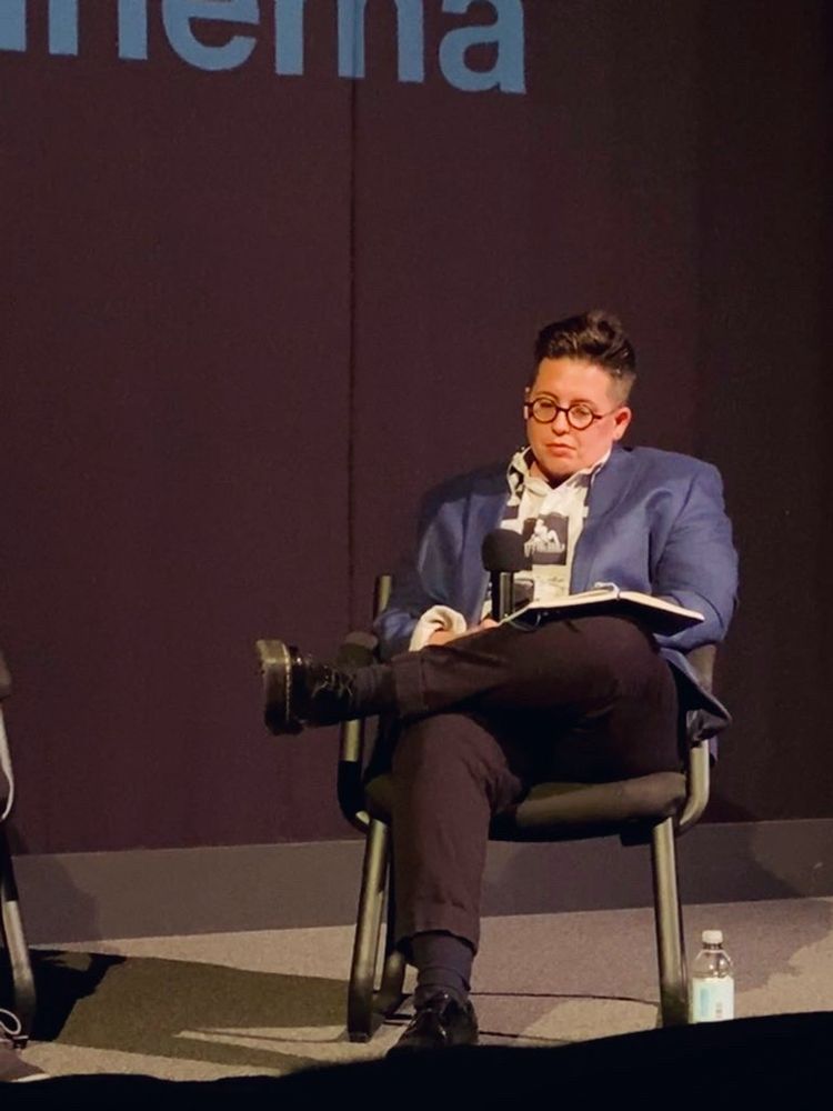 Rox on stage in blue blazer.