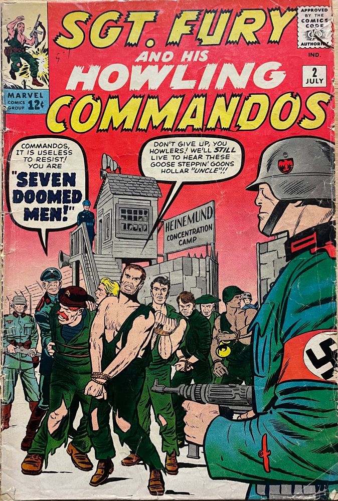 Fury and the Howlers are POWs in a Nazi concentration camp, their hands bound and under armed guard. 