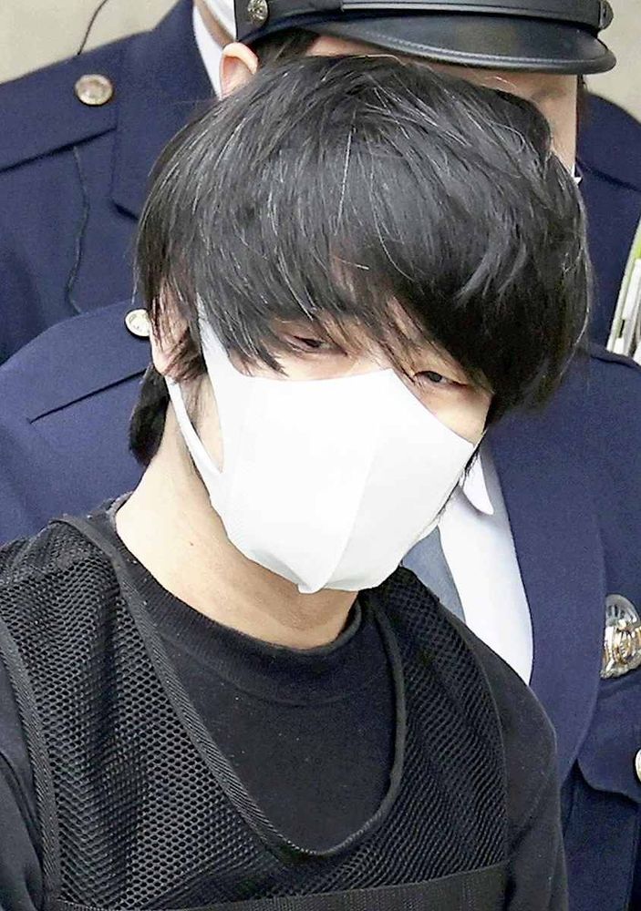 Shinzo Abe assassin, Tetsuya Yamaguchi, surrounded by boars (AKA Japanese swine), masked in white & clad all in black, from his thin unkempt locks, down to his bulletproof vest. Shame you can't see this snack of a comrade.