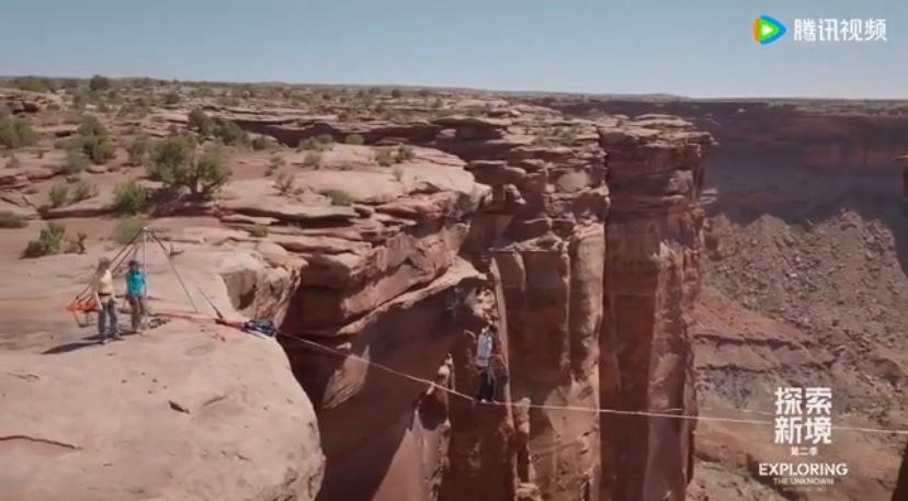 Wang Yibo for ETU2, balancing on a high-wire between two rocks. 