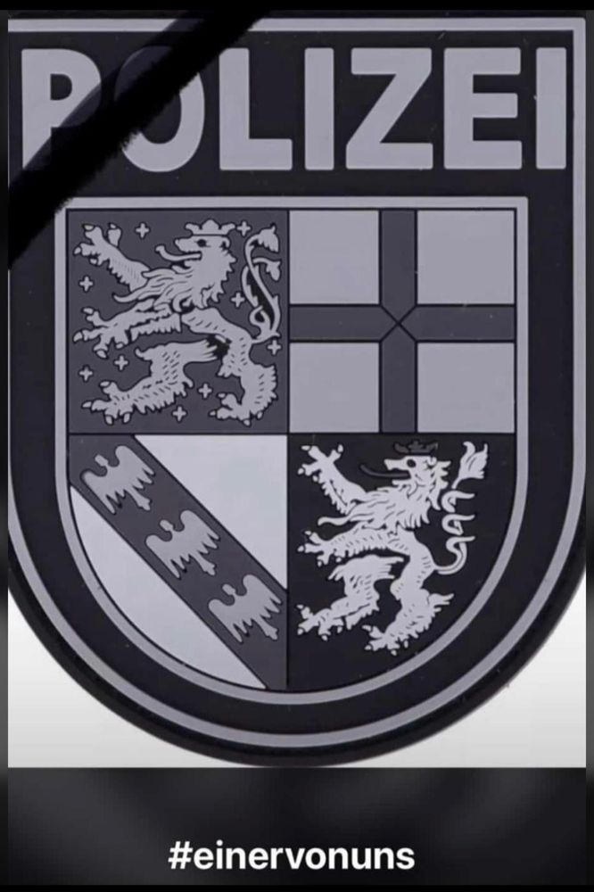 Das Wappen des Saarlandes in Schwarz weiß. Auf Grund des Todes eines Polizisten. Erschossen mit der eigenen Waffe.