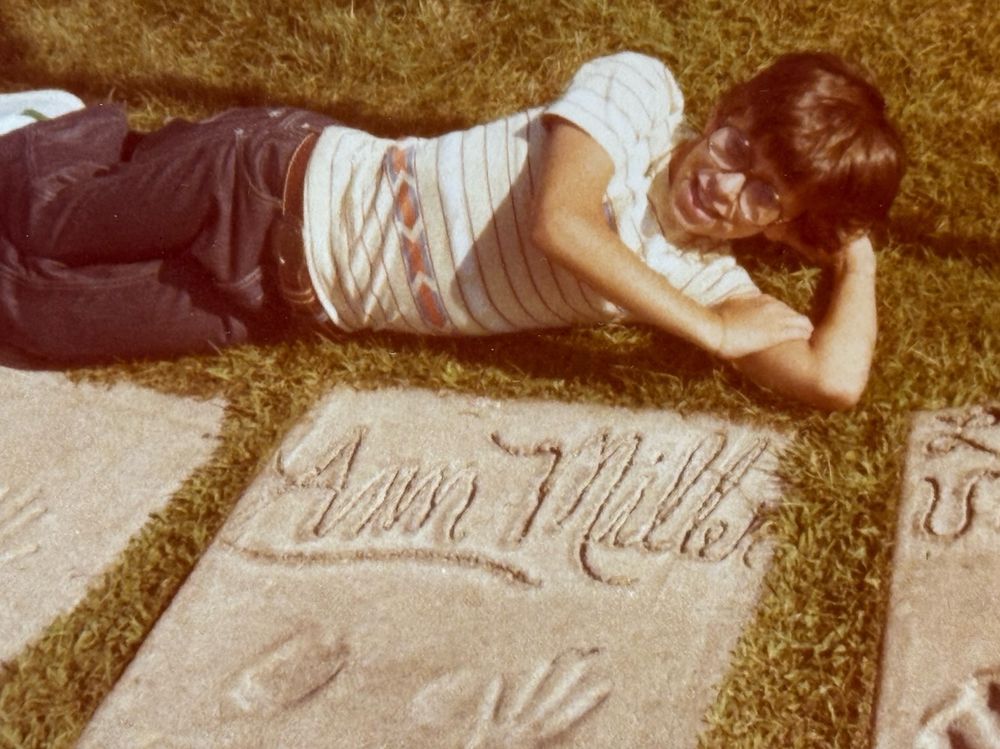 Eight year old me posing with a block of cement with Ann Miller's hand and foot prints. 