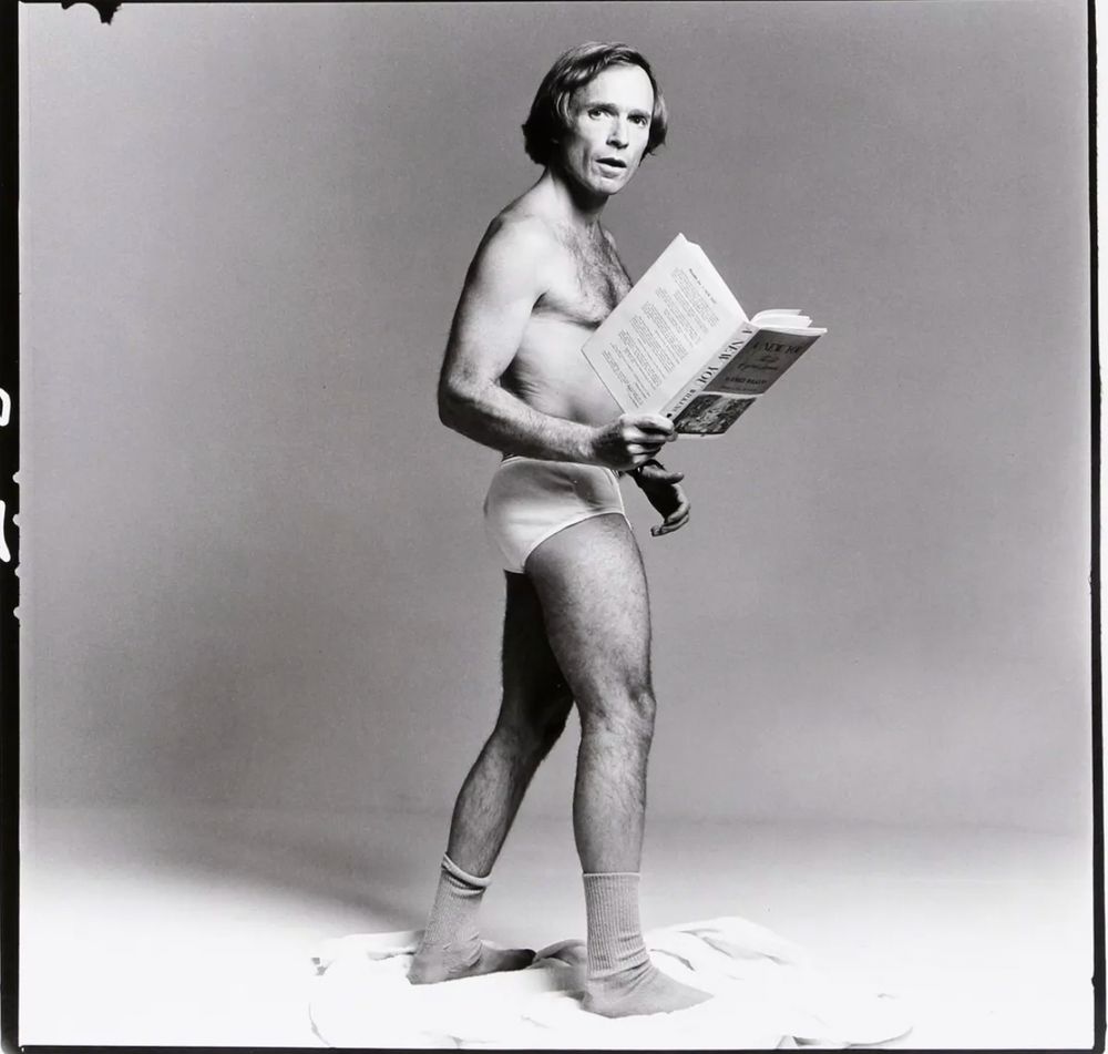 Dick Cavett in white briefs & socks holding a book entitled "A New You."