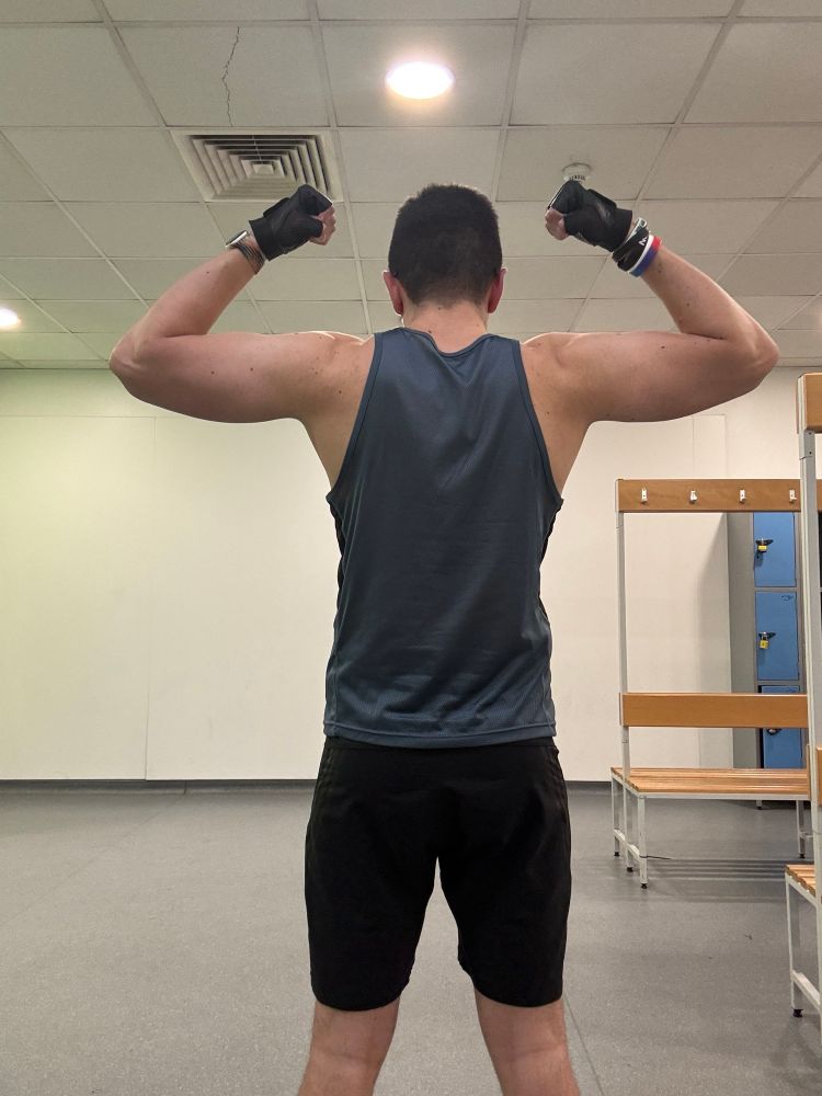Pup Danny flexing seen from the back.