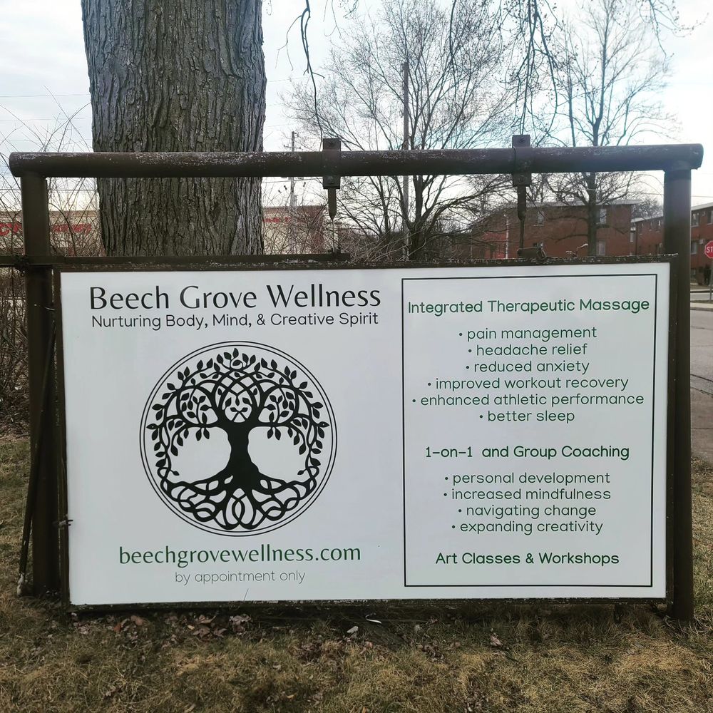 A white sign featuring offerings available at Beech Grove Wellness, including massage, coaching, and art classes. 