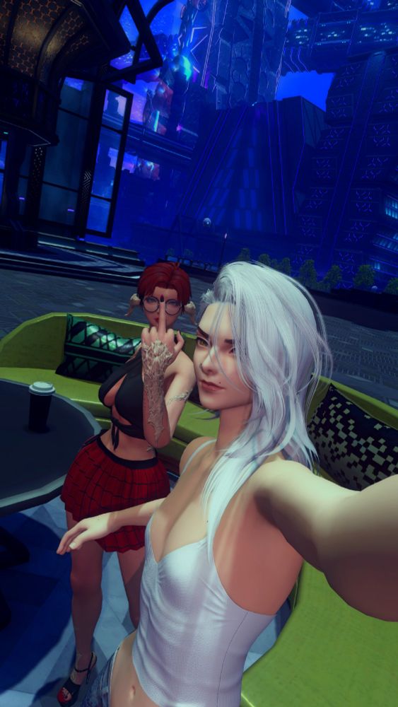 Kai taking a selfie, smirking, after calling Kuri short who is giving the camera the middle finger.