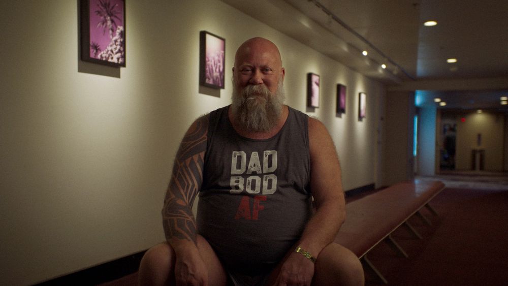 Still frame of Gary Wasdin, AKA Chicago Cigar Dad, sitting and smiling during an interview for Bears, a documentary by Good Pictures