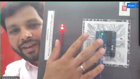 Screenshot of Amit Kumar holding up computer hardware 