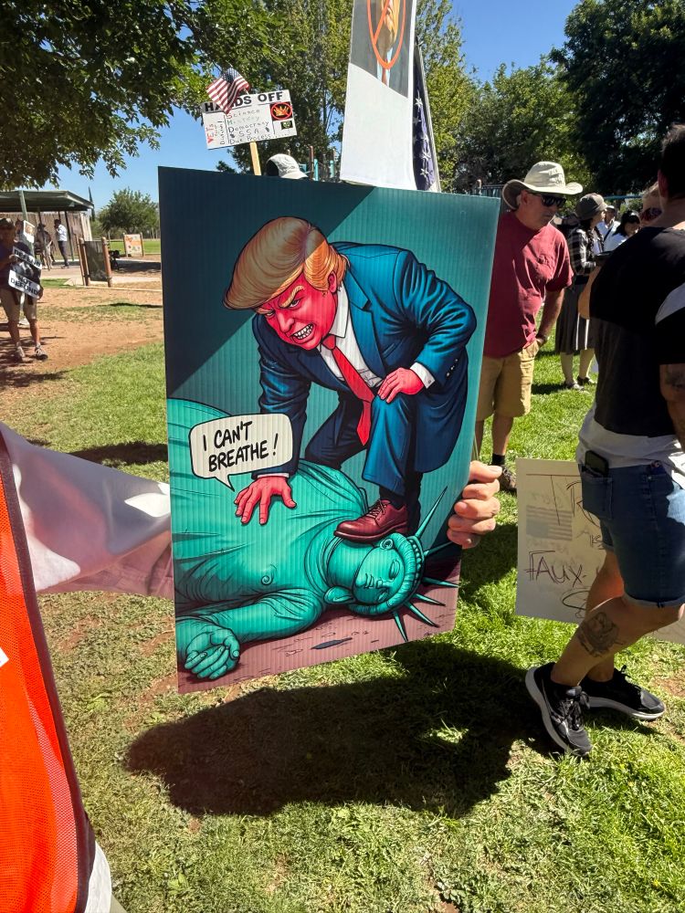 Poster of trump standing in the neck of the Statue of Liberty