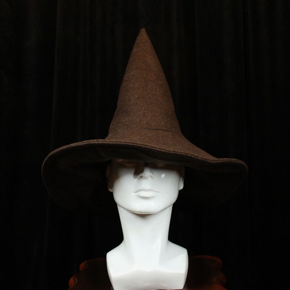 A mannequin head wears a brown woolen witch hat