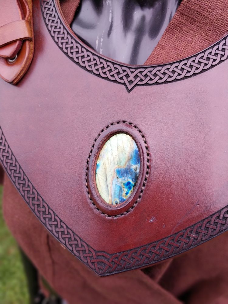 Detail of the elaborate labradorite stone sewn into the leather gorget